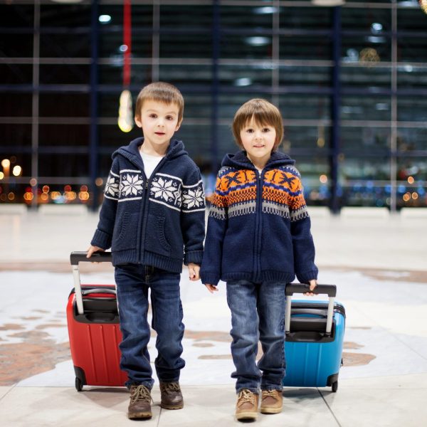 children traveling in an airport at the holidays
